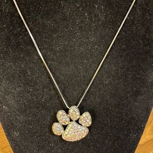 Paw print covered in abalone rhinestones on a silver tone necklace 16 “